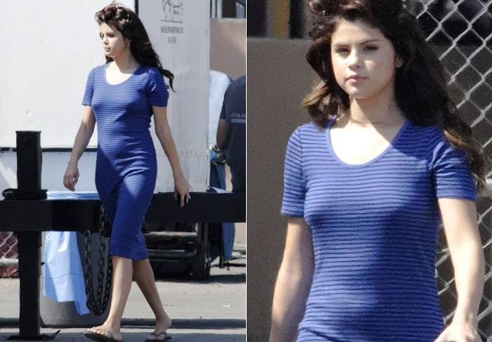 Selena Gomez aparece com barriguinha suspeita em set de filmagem